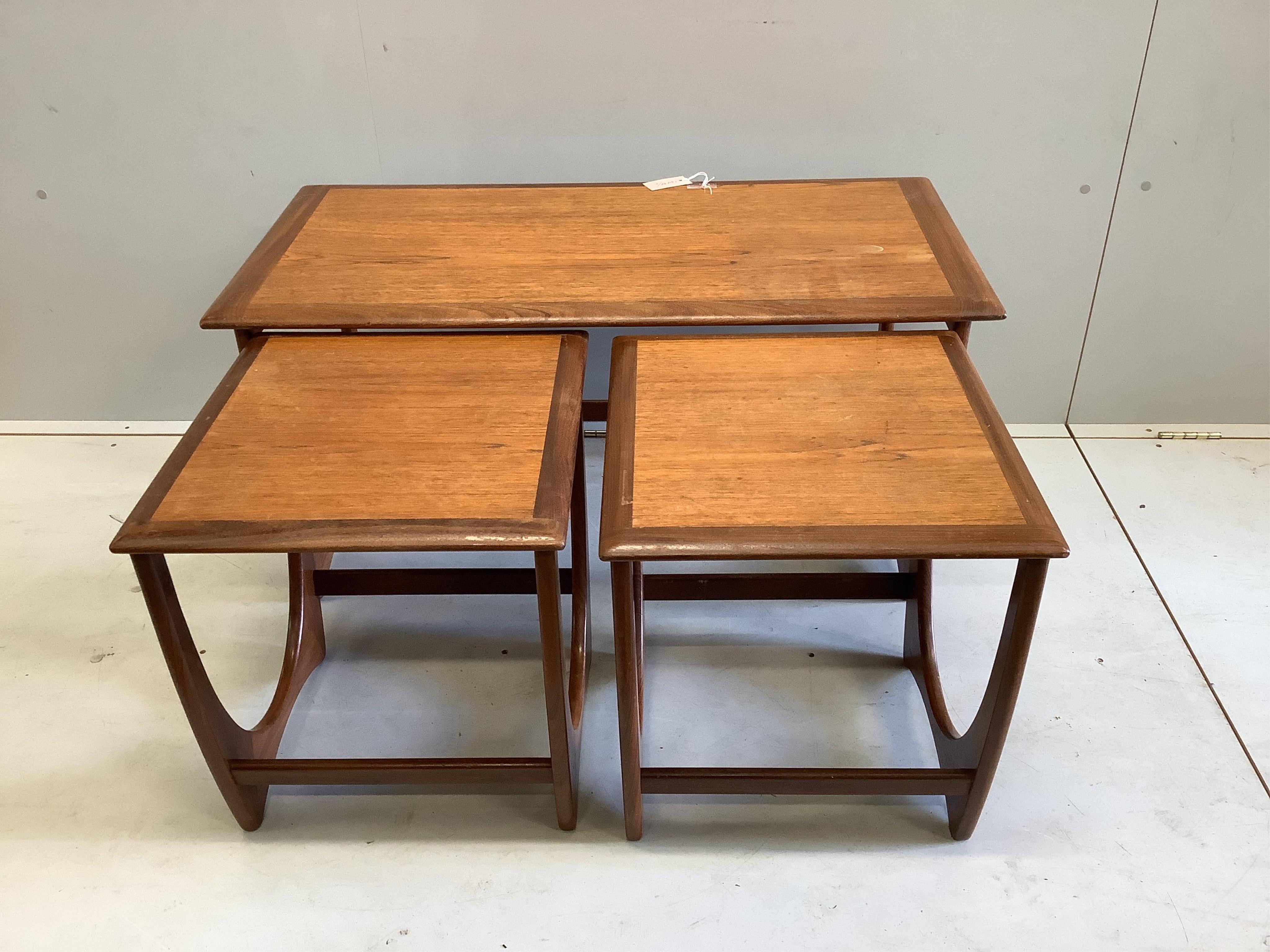 A mid century G Plan teak circular extending dining table, diameter 122cm, four chairs and sideboard, width 138cm, depth 44cm, height 72cm and a nest of tables. Condition - fair